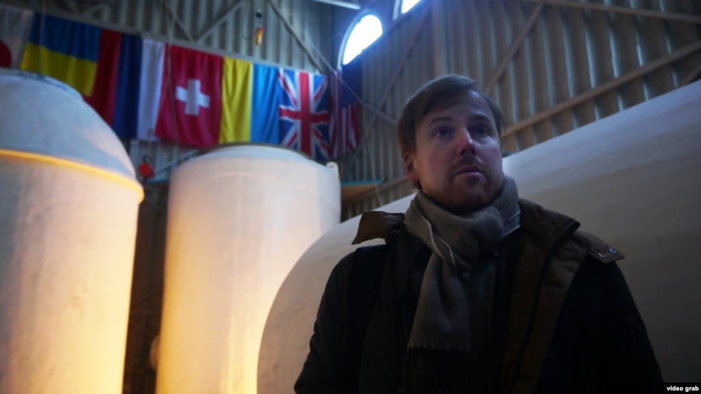 Danila Medvedev, one of the founders of KrioRus, stands in front of vats that contain the frozen remains of his customers.