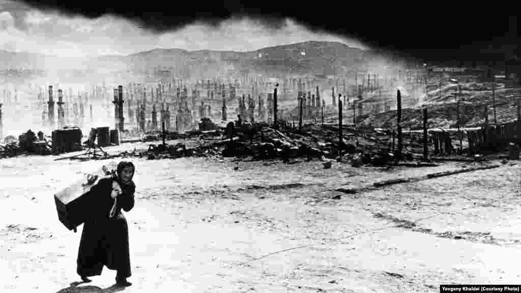 Murmansk after Nazi forces razed the northwestern Russian city with incendiary bombs in 1942. Khaldei remembered that the woman berated him for photographing their tragedy, saying, "Why don't you go to Berlin and photograph how our pilots are bombing it?" The young photographer promised her if he ever reached Germany, he "would do just that."