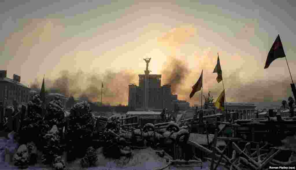 The sun rises over a barricade on Independence Square.