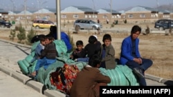 People displaced by fighting rest after fleeing from Jaghori district of the southeastern Ghazni province to escape ongoing battles between Taliban and Afghan security forces on November 15.