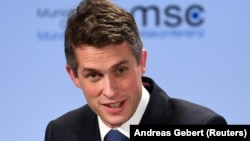 British defense chief Gavin Williamson assails Russia at the Munich Security Conference in Germany on February 15.