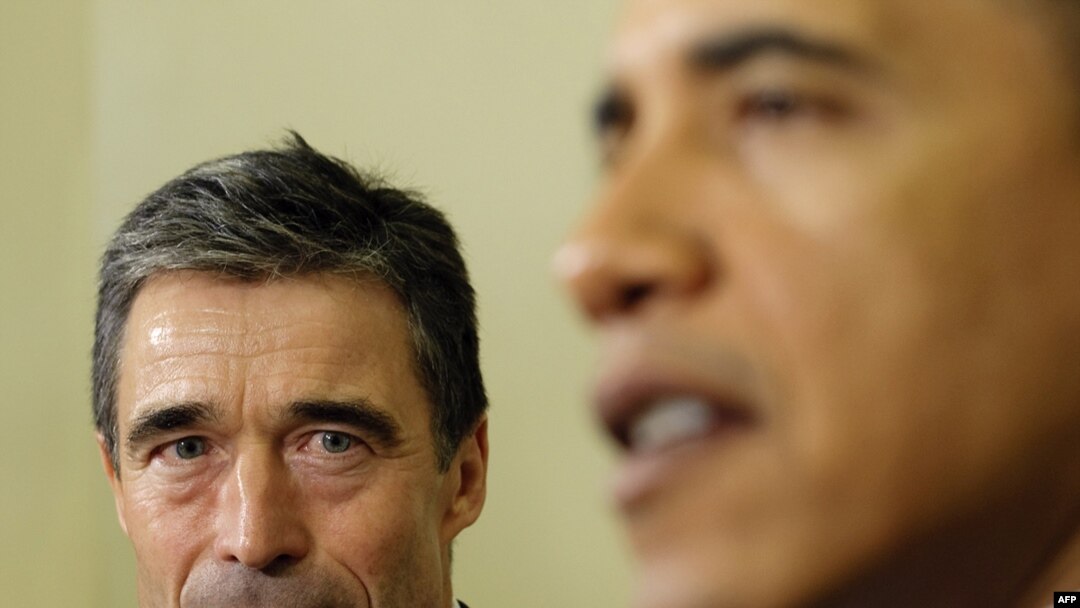 U.S. President Barack Obama (right) speaks to reporters as NATO Secretary-General Anders Fogh Rasmussen looks on during a meeting in the Oval Office of the White House.