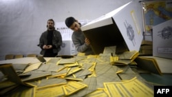 Workers open the ballots in a polling station in downtown Rome on February 25 after the second day of Italy's general elections.