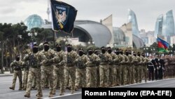 Azerbaijani soldiers march during a military parade dedicated to the victory in the Nagorno-Karabakh armed conflict in Baku in December 2020.