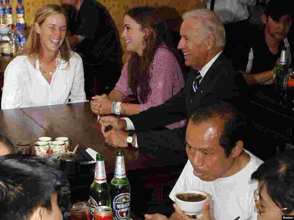 U.S. Vice President Joe Biden smiles during a stop at a local restaurant for lunch with his granddaughter Naomi Biden (in pink) and his daughter-in-law Kathleen Biden (in white) during a visit to Beijing. Biden was in China on the first and most critical leg of an Asian tour that will also take him to Japan and Mongolia.Photo by Ng Han Guan for Reuters