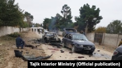 Police investigators work at the site of the attack on the Tajik-Uzbek border.