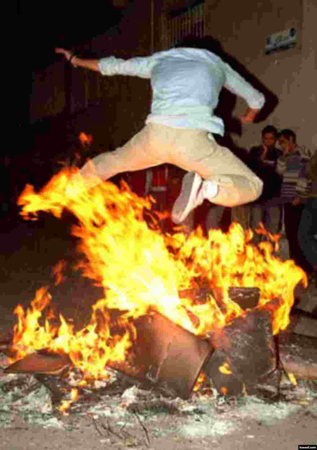 An Iranian boy jumps over a fire in an ancient festival called Chaharshanbe Suri (Wednesday Fire) on the last Wednesday prior to Norouz - http://www.kosoof.com/photo/00080-09-4shanbe-soori.jpg Noruz08