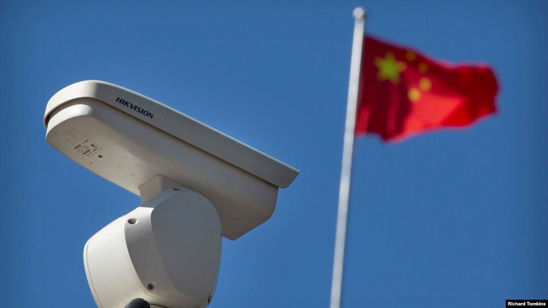 A Hikvision security camera monitors a traffic intersection in Beijing.