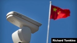 A Hikvision security camera monitors a traffic intersection in Beijing.