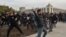 Supporters of politician Sadyr Japarov clash with supporters of former Kyrgyz President Almazbek Atambaev in Bishkek on October 9.