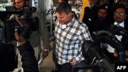 FILE: Raymond Davis (C) heading to a court in Lahore on January 28, 2011