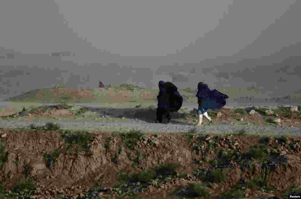 Women walk on a windy day outside Kabul. (Reuters/Mohammad Ismail)