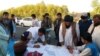 A handful of young Afghan activists are urging people in Helmand to sign long sheets of white paper and also leave their cellphone numbers.