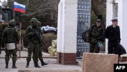 Ukraine -- Ukranian officers (R) leave the navy southern headquarters base in Novoozerne after it was seized by the Russian forces, March 19, 2014