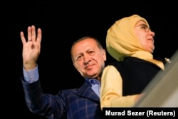 Erdogan with his wife, Emine, greet supporters in Istanbul on April 16.