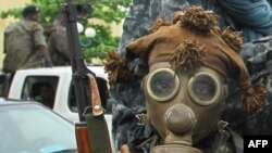 A pro-Ouattara fighter prepares for battle on April 5.