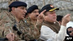 Pakistani Prime Minister Nawaz Sharif (right) speaks with military chiefs as they watch an exercise in November 2013.