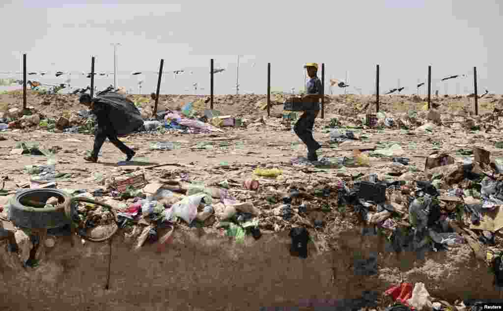 Garbage collectors work at a dump site in Najaf, Iraq. (Reuters/Ahmed Mousa)