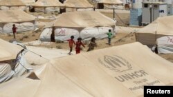 Syrian refugee children play at the Al-Zaatri refugee camp in the city of Mafraq, Jordan. The UN says it has registered 150,000 Syrian refugees in four neighboring countries.