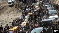 Mourners carry the coffins of the Kurdish victims of a Turkish air raid in its Sirnak province on December 30.