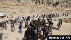 Men carry the coffin of a relative who died in a suicide bombing targeting a training class in a private building in the Shi'ite neighborhood of Dasht-i Barcha, in western Kabul, on August 16.