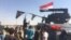 IRAQ -- Kirkuk -- Iraqis gather as Iraqi forces arrive in the first neighbourhood on the southern outskirts of Kirkuk on October 16, 2017. Iraqi forces clashed with Kurdish fighters Monday near the disputed city of Kirkuk, seizing a key military base and 