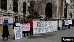 Anti-Ukraine-war protestors stand outside Vienna's Hofburg Palace during a Parliamentary Assembly of the OSCE this week. 