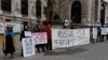Protestors stand outside Hofburg Palace in Vienna as an OSCE meeting takes place on February 23.