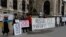 Protestors stand outside Hofburg Palace in Vienna as an OSCE meeting takes place on February 23.