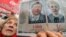 A woman holds a placard with pictures of jailed ex-premier Yulia Tymoshenko and jailed opposition leader Yuriy Lutsenko.