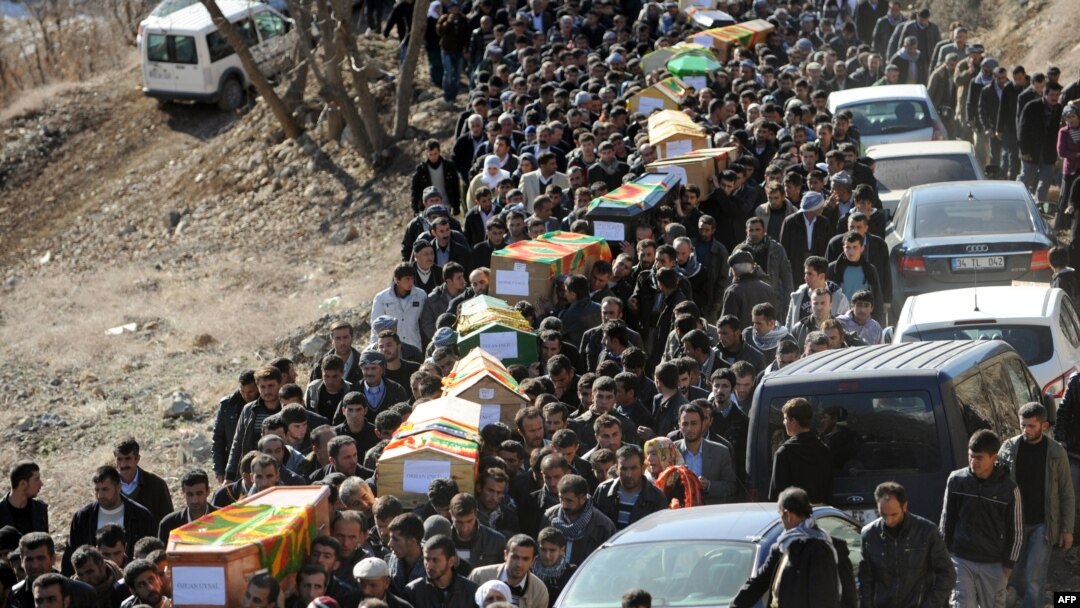 Mourners carry the coffins of the Kurdish victims of a Turkish air raid in its Sirnak province on December 30.