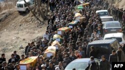 Mourners carry the coffins of the Kurdish victims of a Turkish air raid in its Sirnak province on December 30.