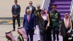 President Donald Trump (front left) walks with Saudi Crown Prince Muhammad bin Salman during an arrival ceremony at the Royal Terminal of King Khalid International Airport in Riyadh on May 13.