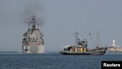 The Russian amphibious landing vessel "Caesar Kunikov" (left) leaves the Black Sea port of Sevastopol in 2012.