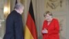 German Chancellor Merkel welcomes Ali Akbar Dabiran, Iran's representative to Germany, during a reception of the diplomatic corps at the German governmental guest house in Meseberg, northeastern Germany on July 9, 2019.