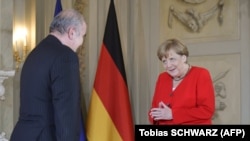 German Chancellor Merkel welcomes Ali Akbar Dabiran, Iran's representative to Germany, during a reception of the diplomatic corps at the German governmental guest house in Meseberg, northeastern Germany on July 9, 2019.