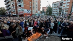Kosovo Serbs in Mitrovica hold a vigil on September 26 for those killed in the attack.