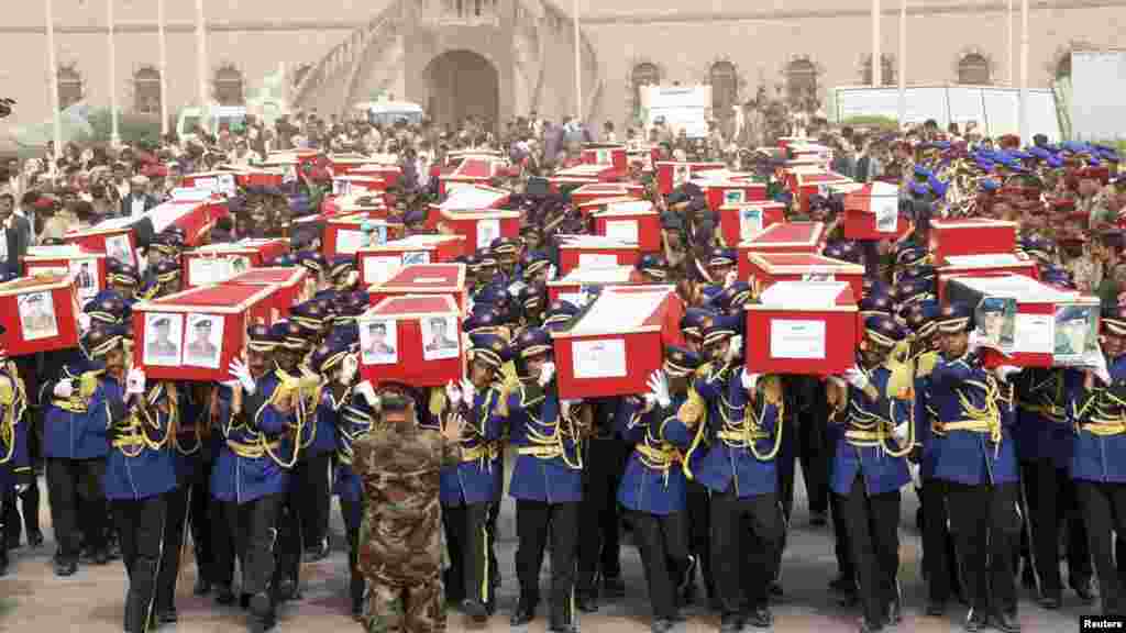 Yemeni soldiers carry coffins on May 24 during the funeral of dozens of troops killed in a suicide bombing in Sanaa three days earlier.&nbsp; (Reuters)