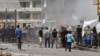 Iraqis gather at the site of a bomb attack in central Baghdad on July 31.