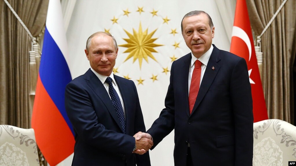 Russian President Vladimir Putin (left) shakes hands with Turkish President Recep Tayyip Erdogan at the Presidential Complex in Ankara on September 28.