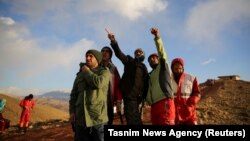 Rescue workers search for a plane that crashed in a mountainous area of central Iran on February 18. 