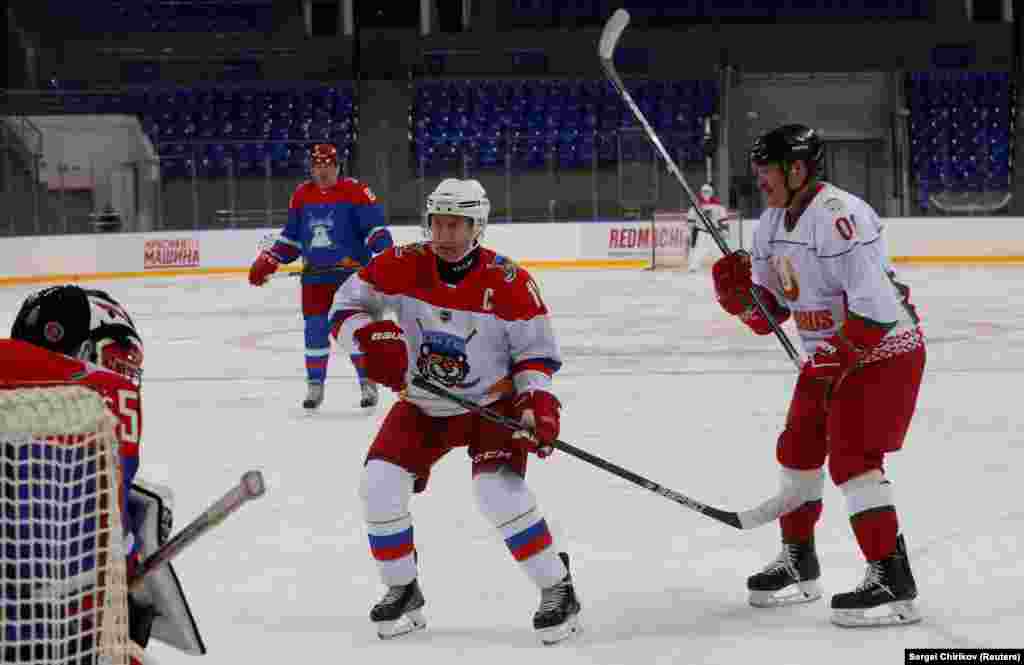 Russian President Vladimir Putin (left) and Belarusian President Alyaksandr Lukashenka play ice hockey in the Black Sea resort of Sochi. (Reuters/Sergei Chirikov)