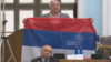 Oopposition Democratic Front deputy Jovan Vucurovic takes out a Serbian tricolor flag during a session of the Montenegrin parliament in Podgorica on March 4.