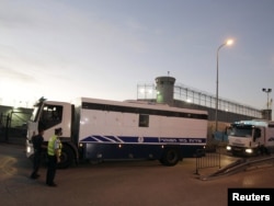 A convoy transporting Palestinian prisoners drives past Ofer prison in the West Bank city of Ramallah early on October 18.