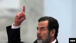 Saddam Hussein reacts to his death sentence at his trial in Baghdad on November 5, 2006.