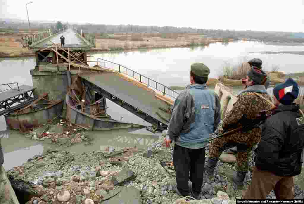 Abkhaz look at the wreckage of the Inguri Bridge. By the end of the war, in September 1993, ethnic Georgians had been killed or driven out of the region and the Inguri River had become the de facto border between Abkhazia and Georgia proper. &nbsp;