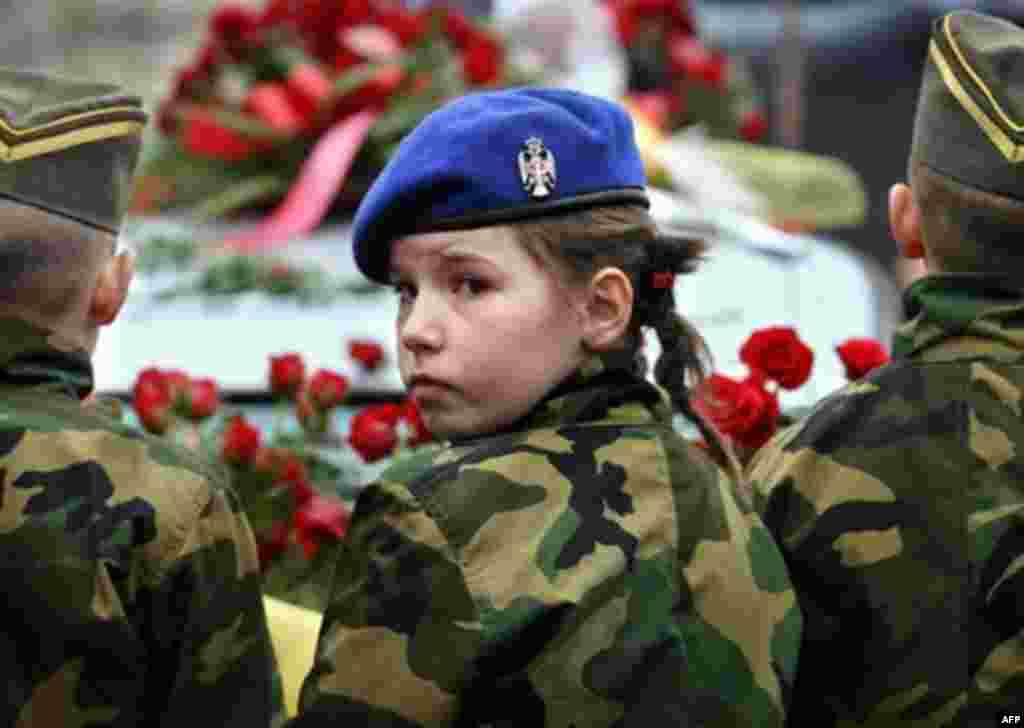 Children pictured in front of the hearse bearing former Serbian leader Slobodan Milosevic to his funeral, in Porarevac (AFP) - In the end, justice was not done. Slobodan Milosevic, the man who accelerated the collapse of Yugoslavia by trying to preserve Serbian power, died in detention before he was judged the mastermind of many of the atrocities committed in the Balkans in the 1990s. Serbia denied him a state funeral and his family remains on the run, but Belgrade hasn't convinced the EU it is serious about catching other war criminals.