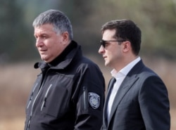 Despite talk from President Volodymyr Zelenskiy (right) of political consequences, Arsen Avakov continues as minister.