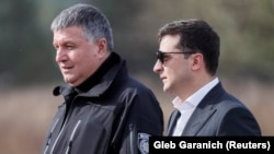 Ukrainian President Volodymyr Zelenskiy (right) and Arsen Avakov, who resigned from his interior minister post on July 13, at a training center in the Kyiv region in September 2019.