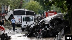 Police and rescue services work at the site of a deadly bomb attack in Istanbul's Vezneciler neighborhood that killed a dozen people. 